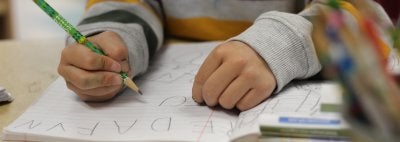 child writing in their journal
